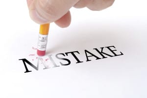 Pencil erasing the word "mistake"