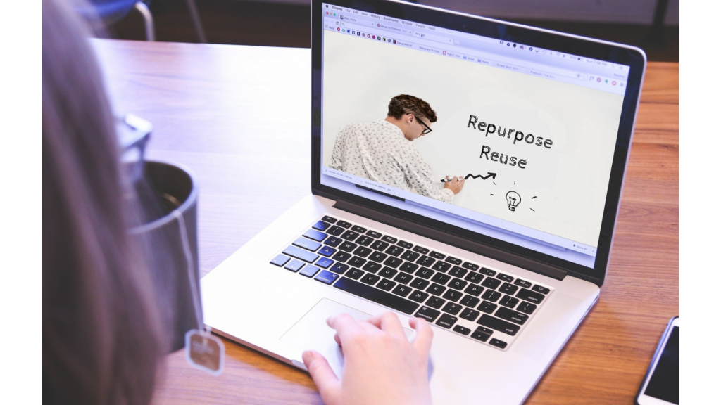 Image of a laptop screen showing a man writing "Repurpose Reuse" on whiteboard.